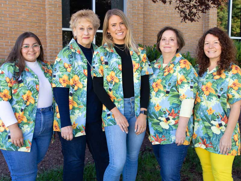 HCC College Advancement department posing together in their HCC branded Hawaiian shirts