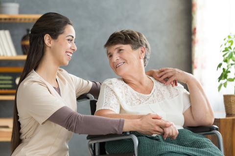 female nursing assistant caring for female patient