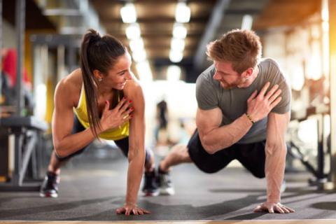 Man and Woman performing a one hand push up
