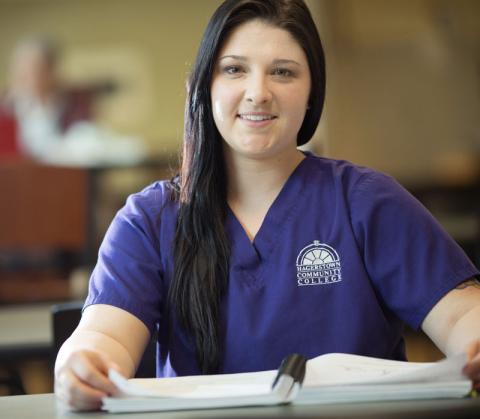 HCC Nursing student reading a textbook